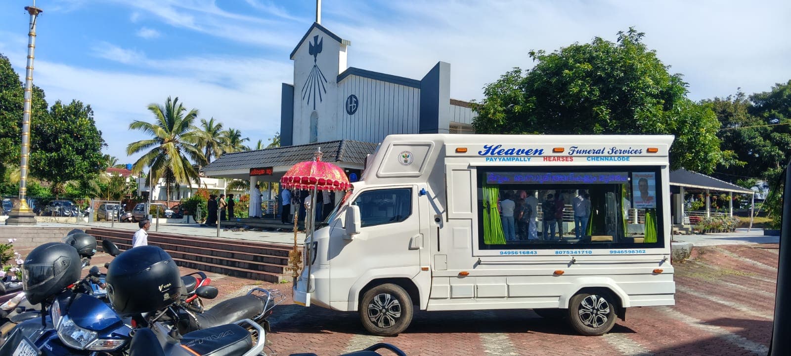 Heaven Funeral Services hearse van at a parish church in Wayanad during a Christian funeral service
