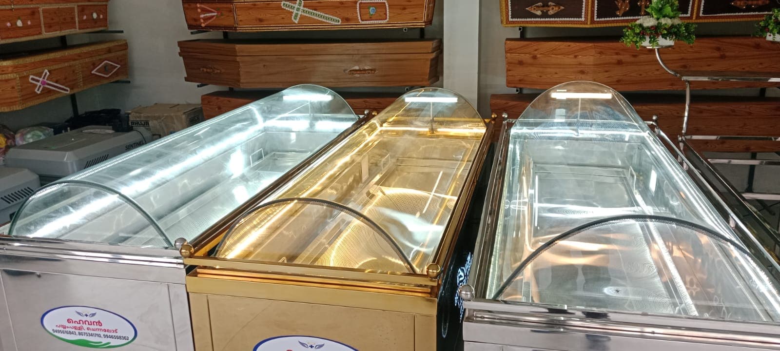 Steel and gold-finished mortuary freezer boxes on rent, lined up at the Heaven Funeral Services showroom in Wayanad