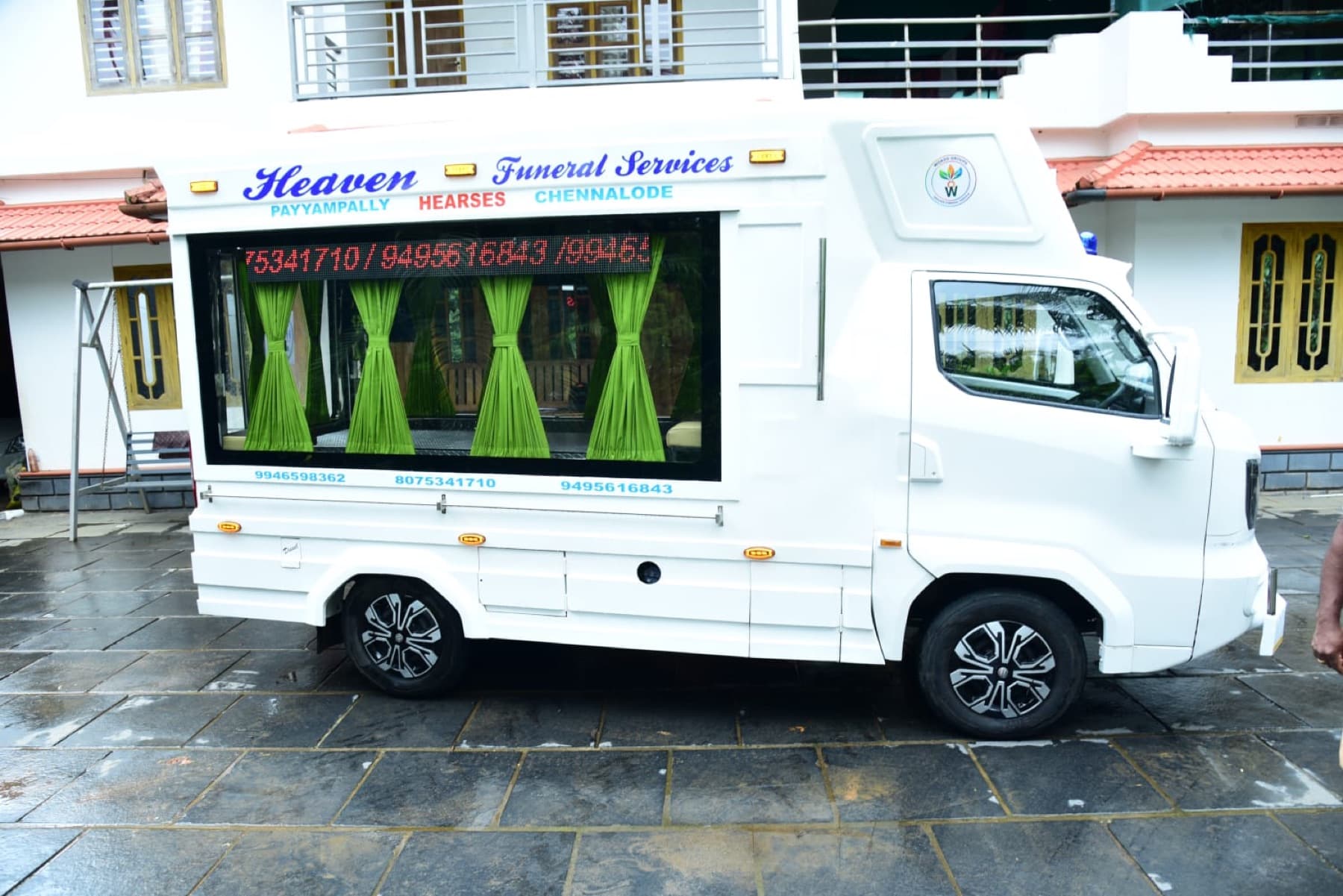 Full side profile of the Heaven Funeral Services transport vehicle