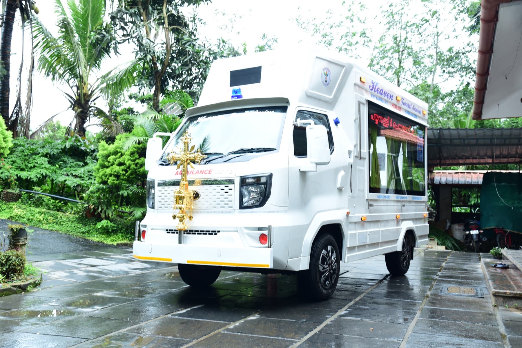 Three-quarter view of the clean white transport vehicle after rainfall