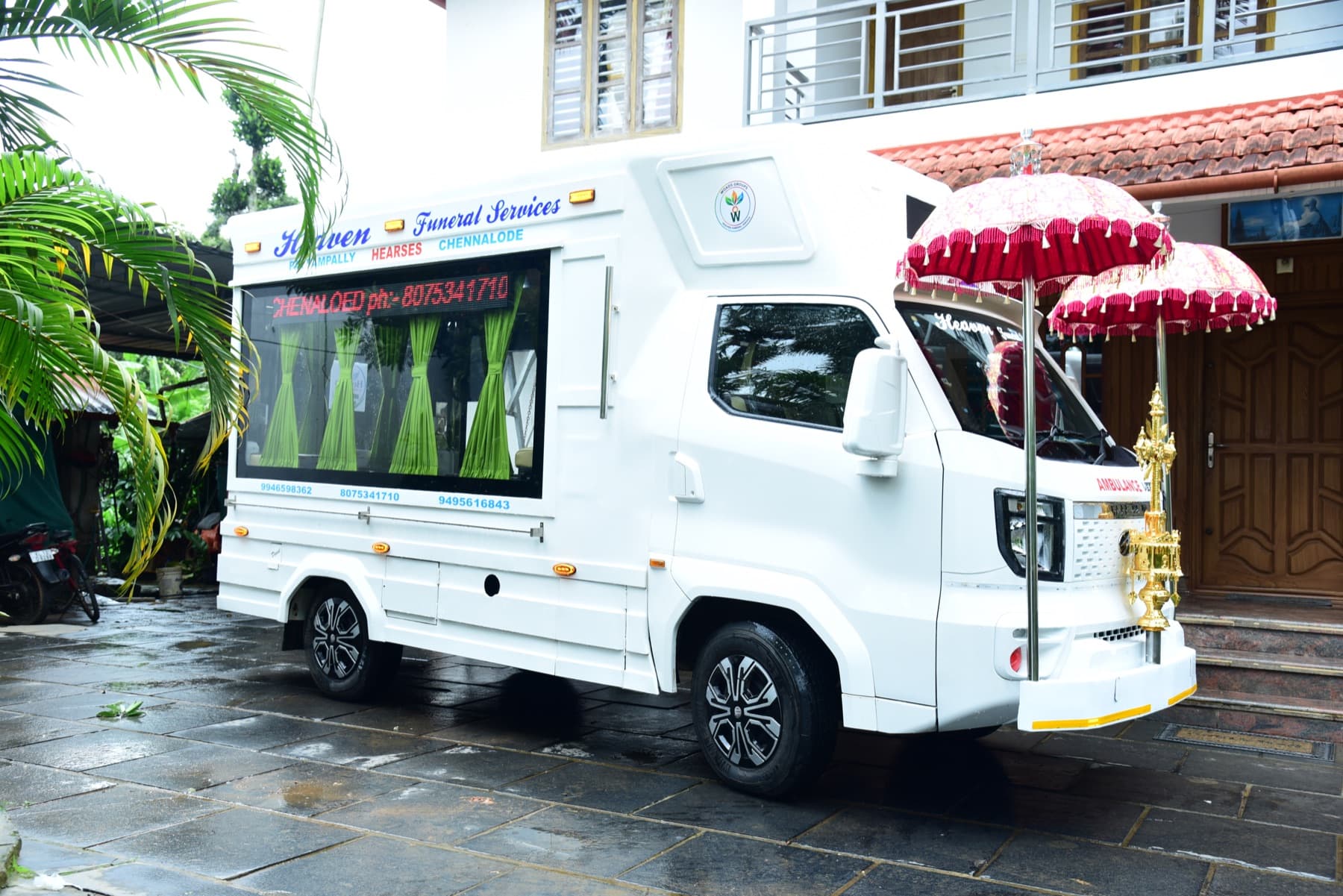 Side view of the Heaven Funeral Services vehicle showing its enclosed transport cabin