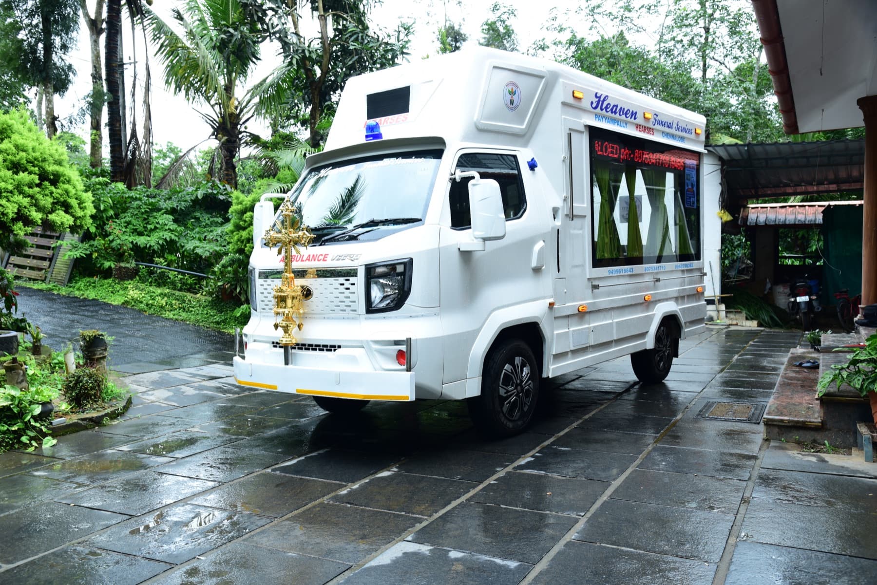Wide view of the Heaven Funeral Services vehicle in its service setting