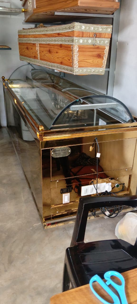 Gold-finished mortuary freezer unit inside the Heaven Funeral Services showroom
