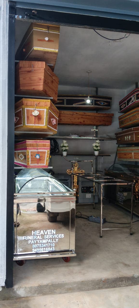 Heaven Funeral Services showroom entrance in Payyampally with a branded mobile freezer unit and coffin displays